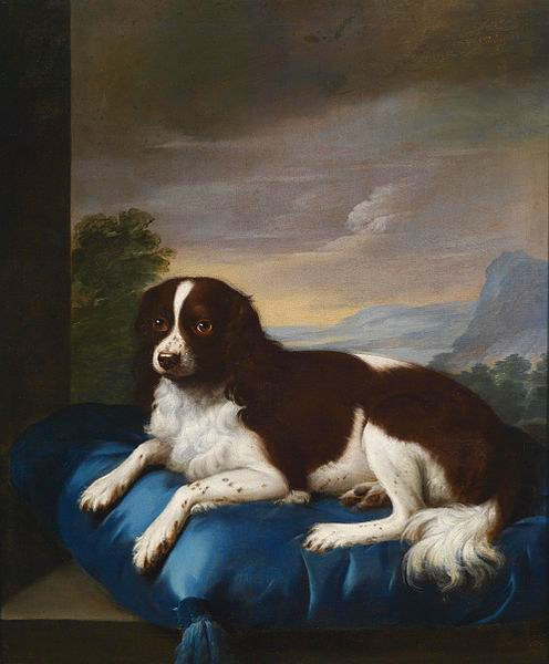 An oil painting of a Springer Spaniel resting on a royal blue pillow with a painted mountain scene in the background.